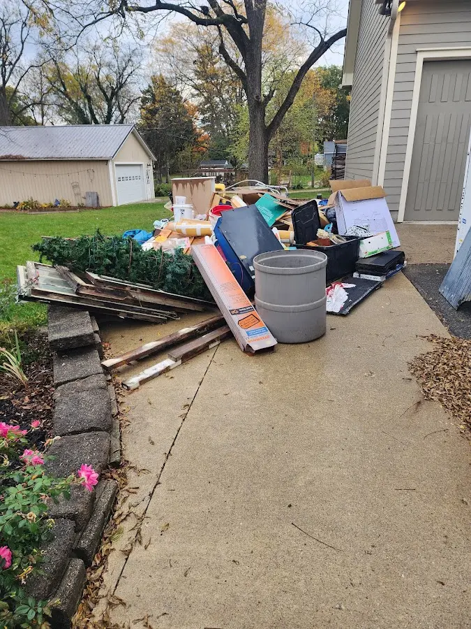Dumpster being loaded with debris for Residential Dumpster Rental in Hamlet